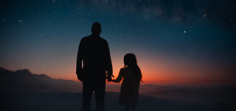 Iris and Augustine stare into the stars in a new dawn Iris holds Augustine's hand while they stare into the stars and a new dawn